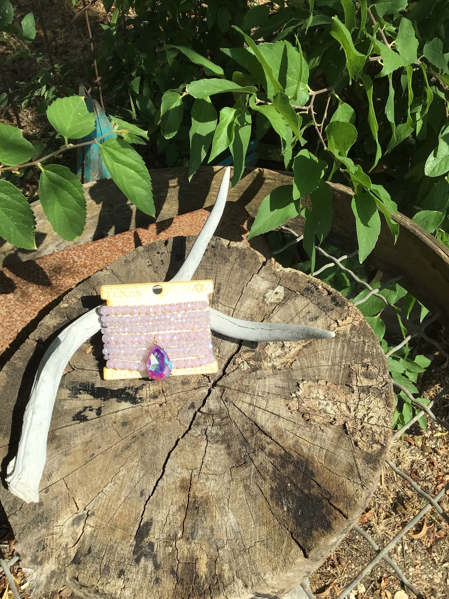 9 strand lilac bead bracelet with large purple rhinestone teardrop